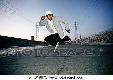 Stock Photography - Hispanic man dancing on urban street. Fotosearch