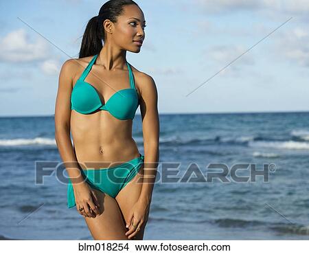 Hispanic woman wearing bikini on beach View Large Photo Image Picture - Hispanic woman wearing bikini on beach. Fotosearch