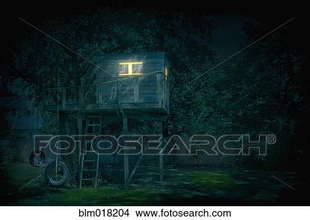Illuminated treehouse in backyard at night View Large Photo Image Picture - Illuminated treehouse in backyard at night. Fotosearch