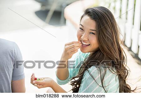 Stock Photo - Japanese woman eating outdoors. Fotosearch