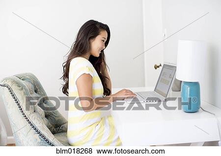 Stock Photo - Japanese woman using laptop. Fotosearch