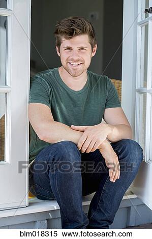 Man sitting in doorway View Large Photo Image Stock Photography - Man sitting in doorway. Fotosearch