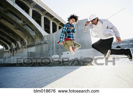 Men break dancing under overpass View Large Photo Image Stock Photograph - Men break dancing under overpass. Fotosearch