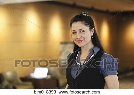 Stock Image - Mixed race businesswoman smiling. Fotosearch