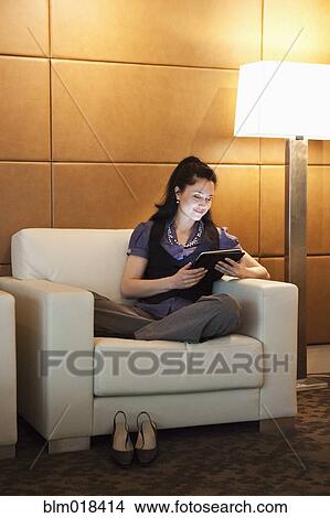 Picture - Mixed race businesswoman using tablet computer. Fotosearch
