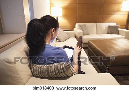 Stock Image - Mixed race businesswoman using tablet computer. Fotosearch