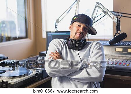 Mixed race disc jockey with arms crossed in studio View Large Photo Image Stock Photo - Mixed race disc jockey with arms crossed in studio. Fotosearch