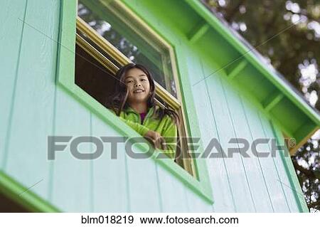 Stock Photo - Mixed race girl leaning out window. Fotosearch