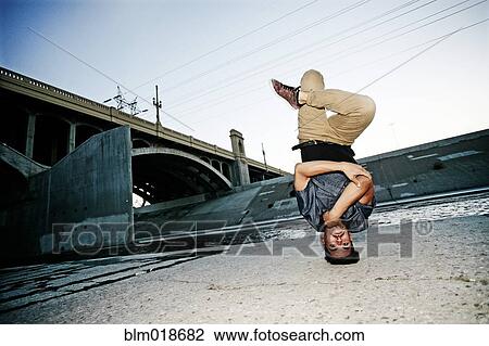 Mixed race man break dancing under overpass View Large Photo Image Stock Image - Mixed race man break dancing under overpass. Fotosearch