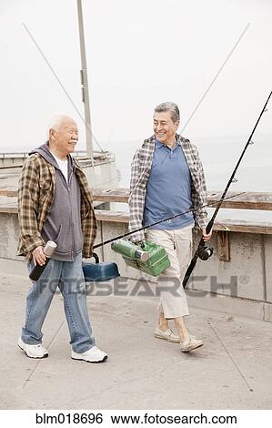 Older men fishing together on dock View Large Photo Image Stock Photograph - Older men fishing together on dock. Fotosearch