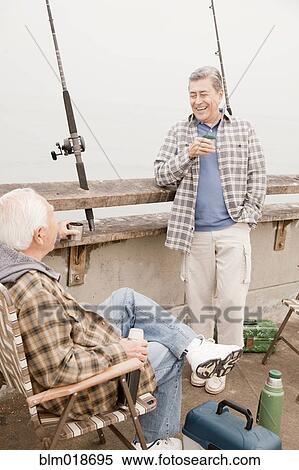 Older men fishing together on dock View Large Photo Image Stock Photography - Older men fishing together on dock. Fotosearch