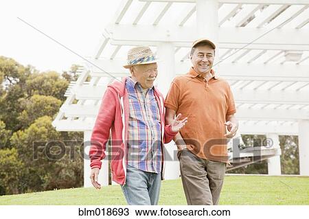 Older men walking together outdoors View Large Photo Image Stock Image - Older men walking together outdoors. Fotosearch