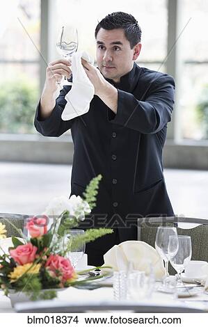 Pacific Islander waiter setting table in dining room View Large Photo Image Picture - Pacific Islander waiter setting table in dining room. Fotosearch