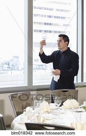 Pacific Islander waiter setting table in dining room View Large Photo Image Stock Image - Pacific Islander waiter setting table in dining room. Fotosearch