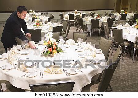 Pacific Islander waiter setting tables in dining room View Large Photo Image Stock Image - Pacific Islander waiter setting tables in dining room. Fotosearch