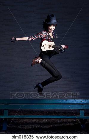 Thai woman jumping with guitar View Large Photo Image Stock Photography - Thai woman jumping with guitar. Fotosearch