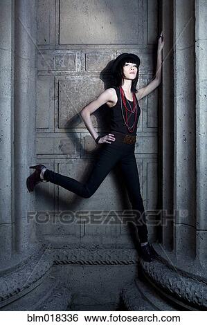 Stock Photograph - Thai woman playing on stone columns. Fotosearch