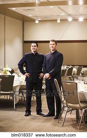 Waiters smiling in dining room View Large Photo Image Stock Photo - Waiters smiling in dining room. Fotosearch