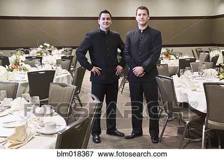 Waiters smiling in dining room View Large Photo Image Stock Photo - Waiters smiling in dining room. Fotosearch