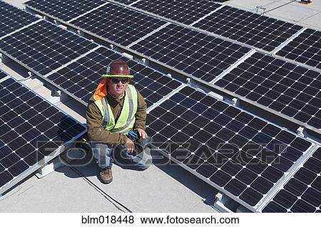 Worker sitting with solar panels outdoors View Large Photo Image Stock Photo - Worker sitting with solar panels outdoors. Fotosearch