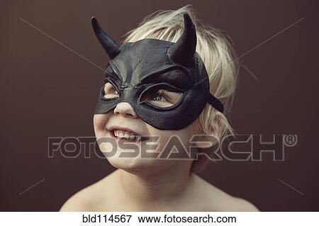 Stock Photo - Caucasian boy wearing mask. Fotosearch