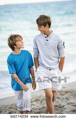 Caucasian boys walking on beach View Large Photo Image Picture - Caucasian boys walking on beach. Fotosearch