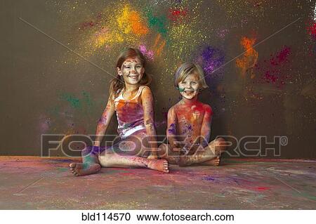 Stock Image - Caucasian children playing with paint. Fotosearch
