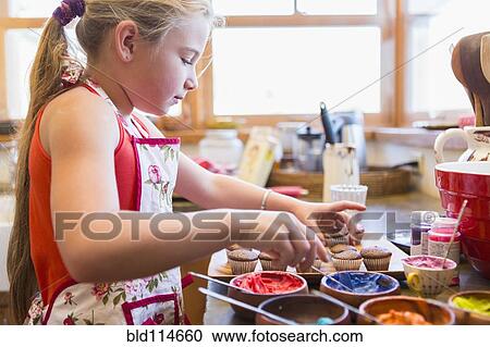 Caucasian girl making cupcakes View Large Photo Image Stock Image - Caucasian girl making cupcakes. Fotosearch