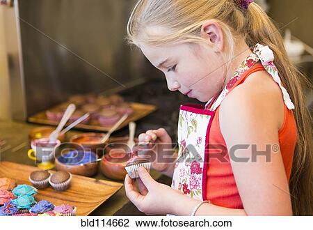 Caucasian girl making cupcakes View Large Photo Image Stock Image - Caucasian girl making cupcakes. Fotosearch