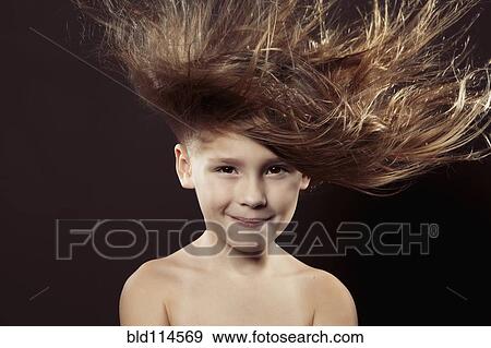 Caucasian girl with hair blowing in wind View Large Photo Image Stock Photo - Caucasian girl with hair blowing in wind. Fotosearch