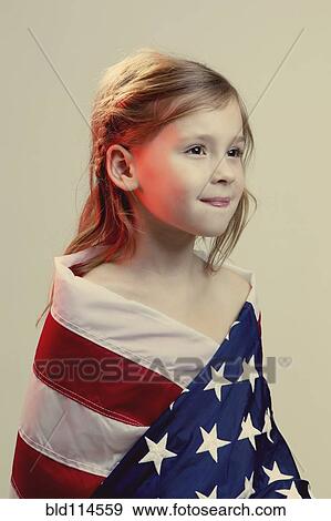 Stock Photo - Caucasian girl wrapped in American flag. Fotosearch