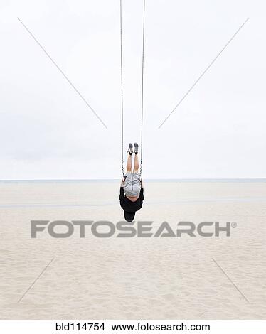 Picture - Caucasian man practicing gymnastics outdoors. Fotosearch