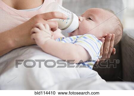 Caucasian mother bottle feeding baby View Large Photo Image Stock Image - Caucasian mother bottle feeding baby. Fotosearch
