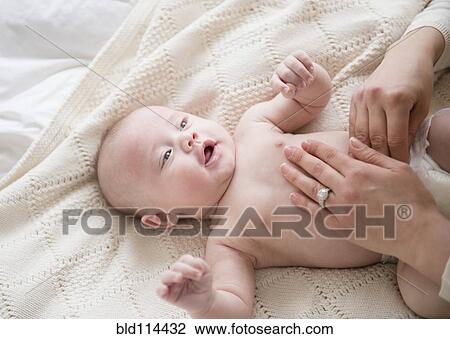 Caucasian mother changing baby's diaper View Large Photo Image Stock Image - Caucasian mother changing baby's diaper. Fotosearch