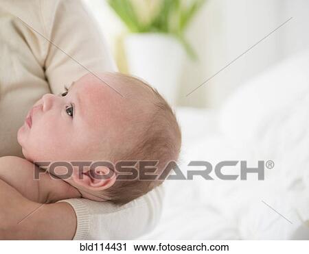 Stock Image - Caucasian mother holding baby. Fotosearch