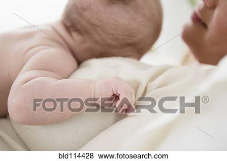 Stock Photo - Caucasian mother kissing baby. Fotosearch