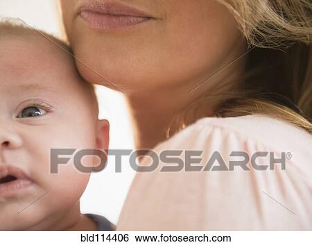 Stock Photograph - Caucasian mother smiling with baby. Fotosearch