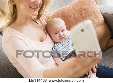 Caucasian mother taking picture of herself and baby View Large Photo Image Stock Image - Caucasian mother taking picture of herself and baby. Fotosearch