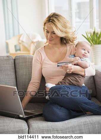 Caucasian mother with baby shopping online View Large Photo Image Stock Image - Caucasian mother with baby shopping online. Fotosearch