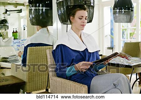 Picture - Caucasian woman having hair done in salon. Fotosearch