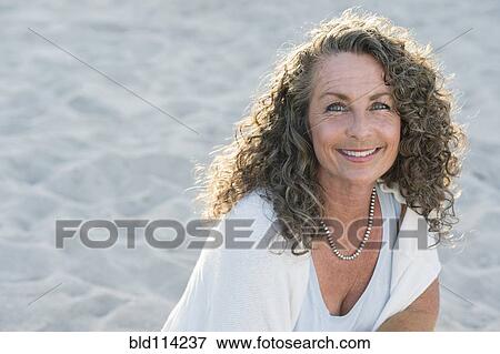 Caucasian woman smiling on beach View Large Photo Image Stock Photo - Caucasian woman smiling on beach. Fotosearch