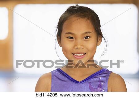 Chinese girl smiling in gym View Large Photo Image Stock Photography - Chinese girl smiling in gym. Fotosearch