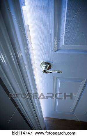 Stock Photo - Close up of handle on open door. Fotosearch