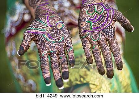 Stock Photo - Close up of hands with intricate henna design. Fotosearch