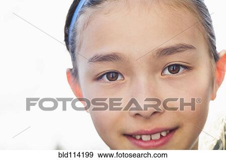 Stock Photo - Close up of mixed race girl smiling. Fotosearch