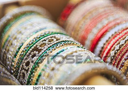 Stock Photo - Close up of rows of bangles for sale. Fotosearch