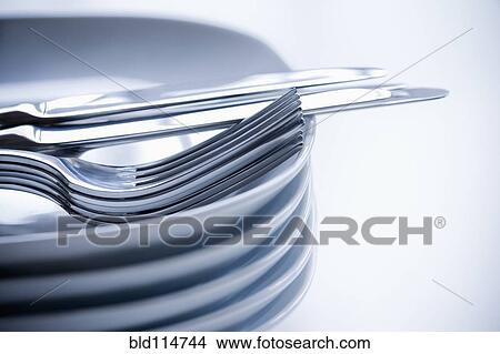 Close up of silverware and stacked plates View Large Photo Image Picture - Close up of silverware and stacked plates. Fotosearch