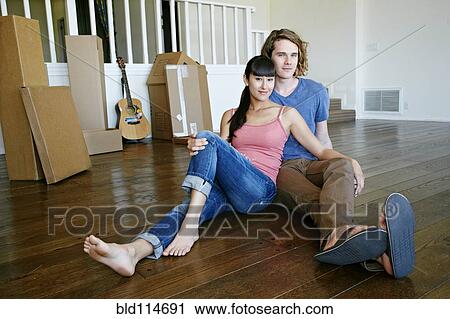 Couple relaxing in new home View Large Photo Image Stock Image - Couple relaxing in new home. Fotosearch