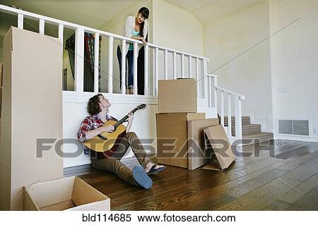 Couple relaxing in new home View Large Photo Image Stock Photography - Couple relaxing in new home. Fotosearch