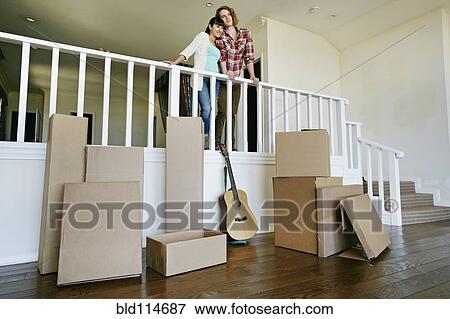 Couple smiling in new home View Large Photo Image Stock Photo - Couple smiling in new home. Fotosearch
